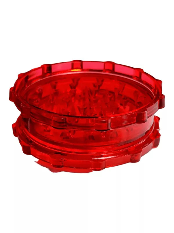 Hexagonal acrylic grinder with transparent body, white base, and red translucent circles on top for smoking.