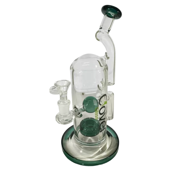 Green glass water pipe with wooden base and small bowl. Glass chamber has center hole surrounded by smaller holes. Blue accents. Smooth wood base with grooves.