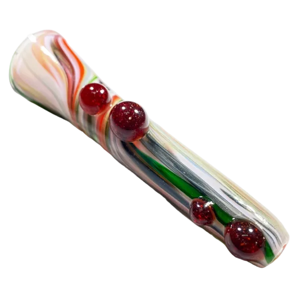 Jem Glass' Pastel Party Chillums are long, curved glass pipes with red and green marbles on them. The pipe has a clear, swirled design and sits on a white background.