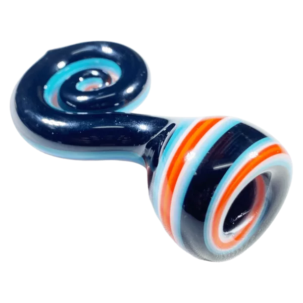 Glass pipe with spiral design in blue, orange, and white on green surface.