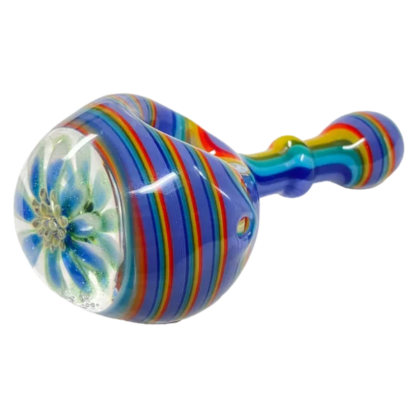 Vibrant, eye-catching glass pipe with a flower design made of blue, green, and purple glass. Long, curved shape with clear glass stem and bowl. Small, round base. Abstract design on bowl.