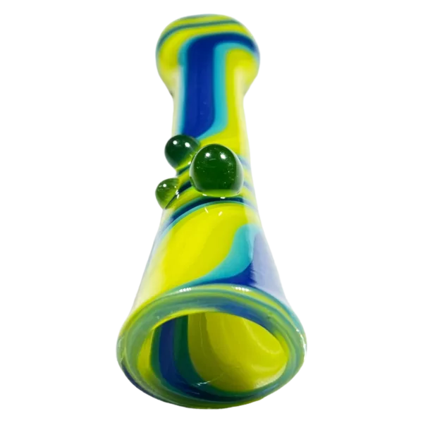 Large glass pipe with blue and yellow swirl design, clear glass tube, and small round base on white background. Lined Bat - Jem Glass.