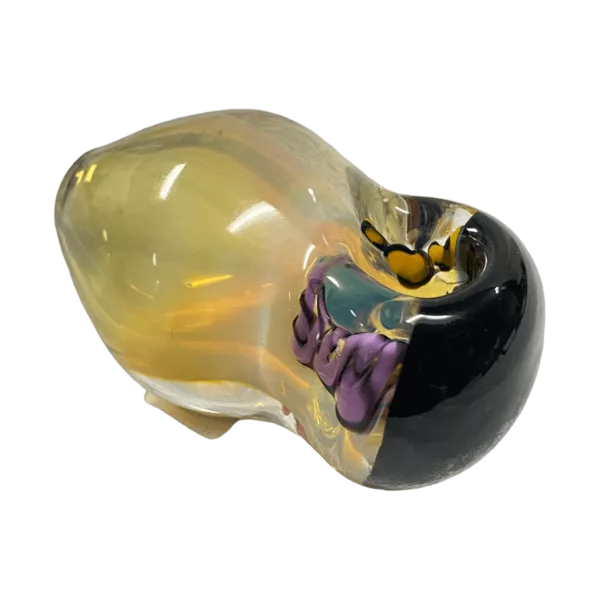 Glass sculpture of a human head with intricate yellow, black, and purple patterns, perfect for a unique smoking experience.