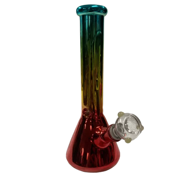 A colorful glass bong with a clear base and stem, featuring a small and large hole, and sitting on a green surface. Available from BVTAN054 on a smoking company website.
