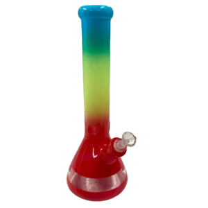 Rainbow colored glass bong with clear base and stem, sitting on green background.