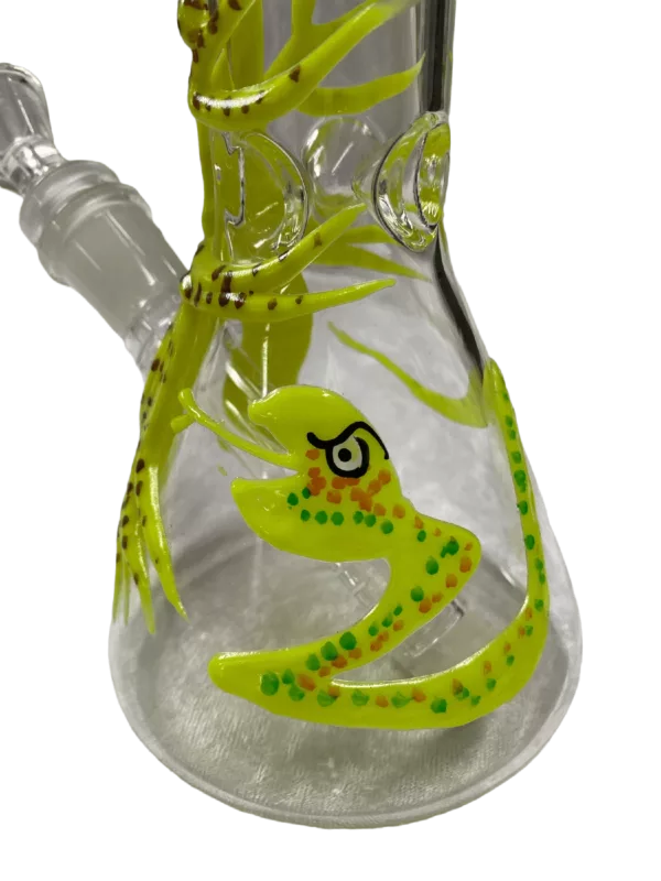 Image of glass bong with yellow and green snake design. Long, curved shape, small round base. Clear stem with small round mouthpiece. White background.