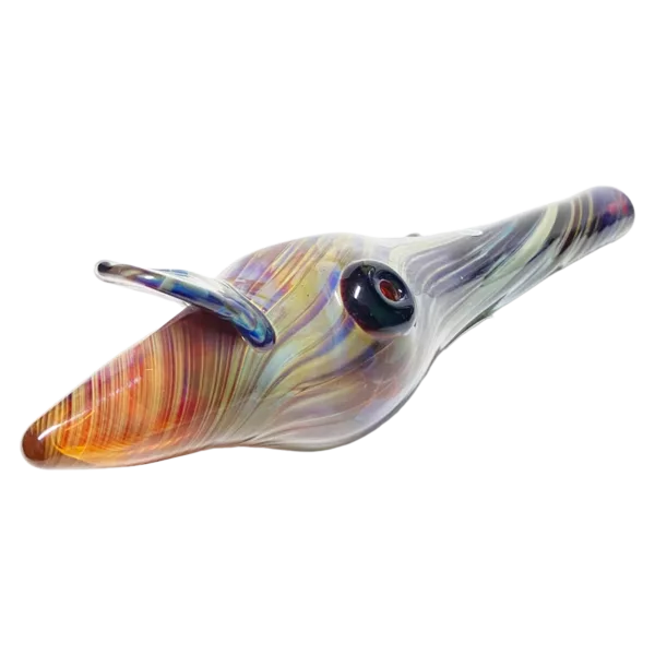 Chameleon Glass Purple Conch sculpture depicts a swimming dolphin with a large, round head and multi-colored body. The design exudes movement and fluidity.