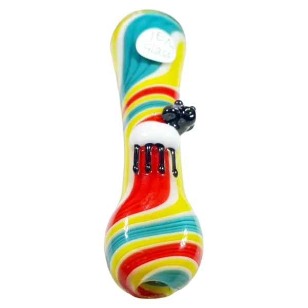 Colorful glass pipe with rainbow design and small and large holes. Sitting on white background. Features sculpted animal design.