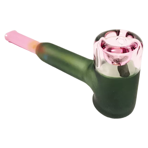 A glass pipe with a pink stem and green base, curved stem and flat base. Pink tip. unclear contents.