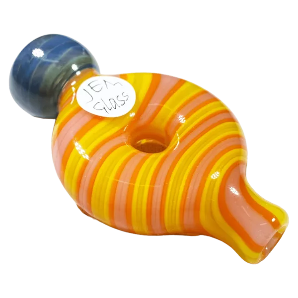 Image of glass pipe with yellow, orange, and blue striped design. Long, curved neck and small, round base decorated with circular designs. Advertises Striped Donut Chillum by Jem Glass.