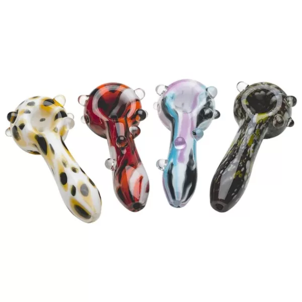 This image features a set of four colorful, abstract glass pipes with curved shapes and small holes, arranged in a row on a white background. They are marketed as Psychedelic Glass Spoons by Empire Glass.