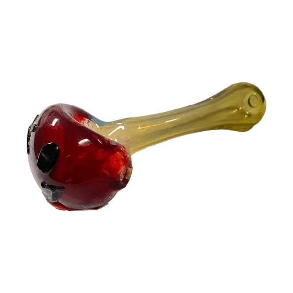 Red glass skull pipe with yellow tip and small hole. Clear glass, red skull. #TC6212