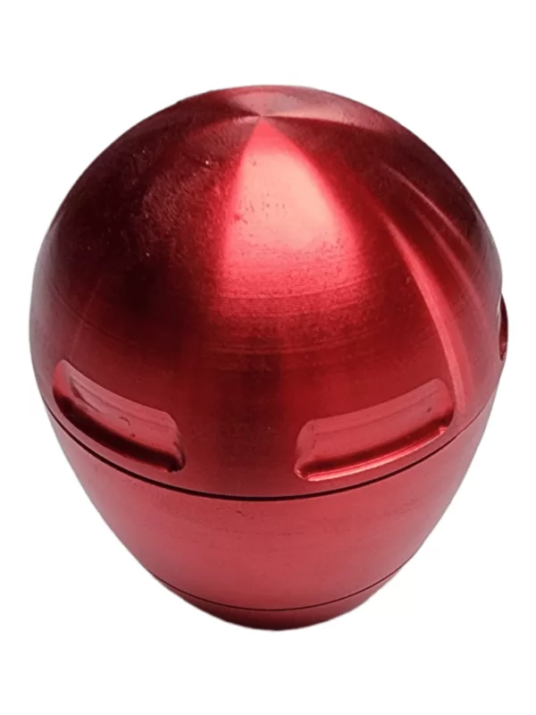 Metal egg grinder with red base and lid, no handles or knobs.