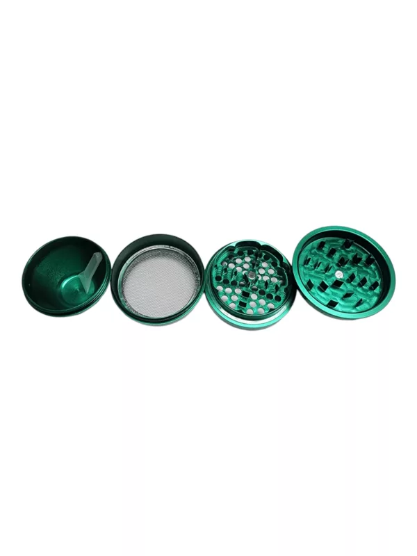 green metal grinder with small holes on top and a plastic base, featuring a small handle.