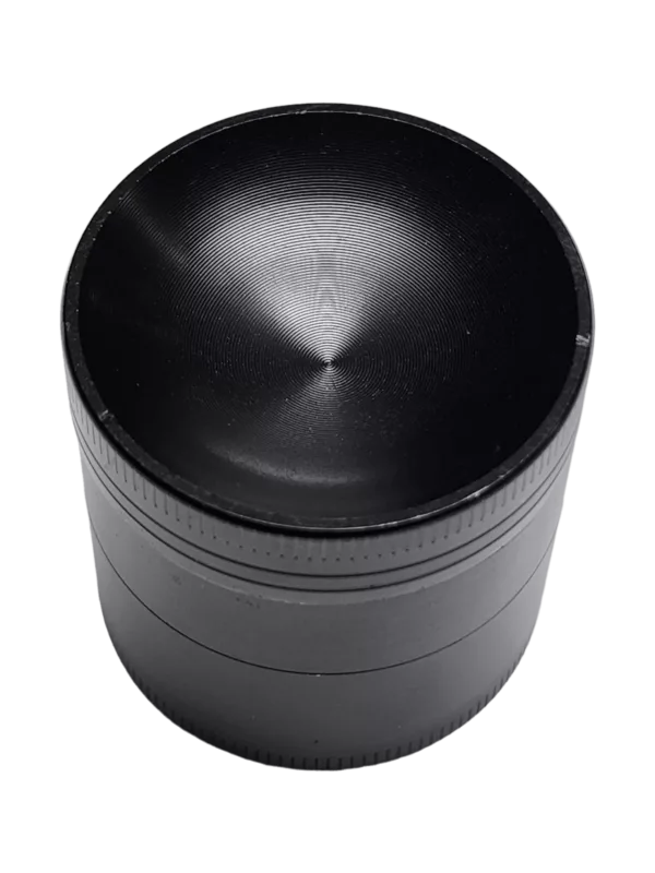 A concave black metal grinder with no visible details.