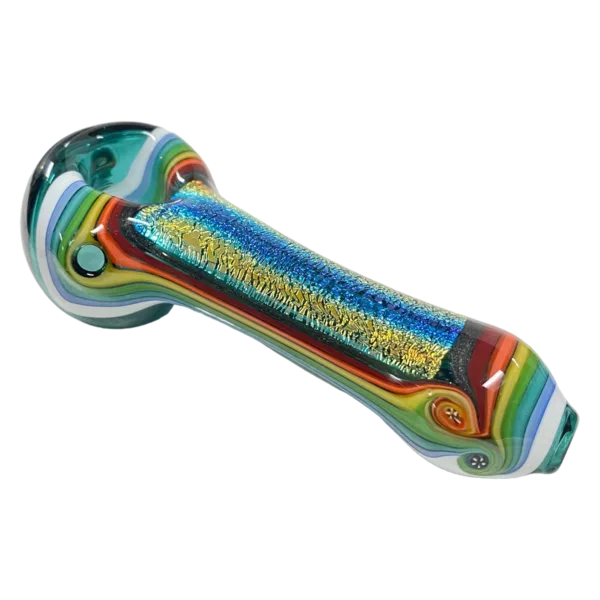 Multicolored glass spoon shaped like a rainbow, with a blue, purple, yellow, green, and red handle. Clear shaft and white background.