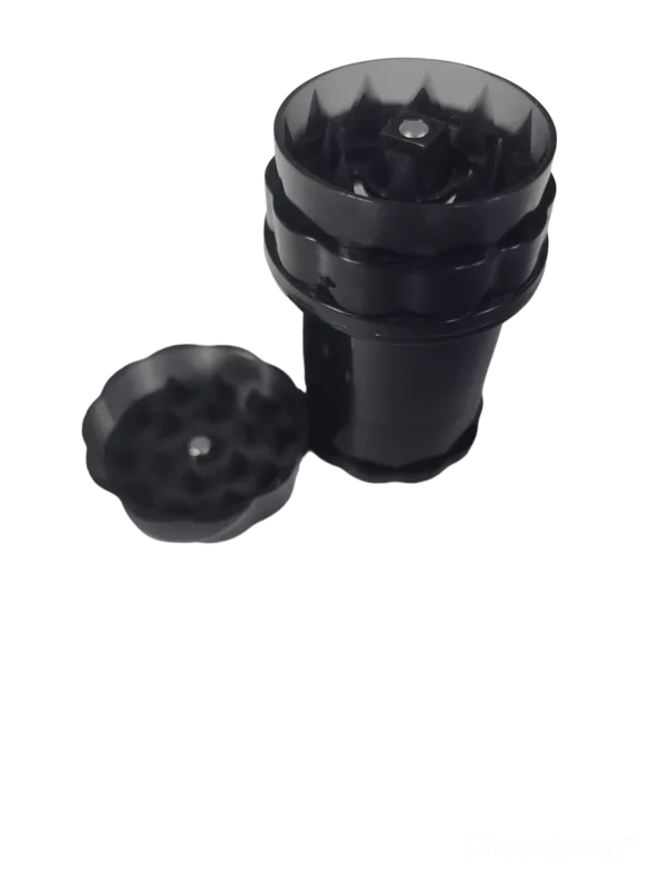 Black plastic container with round shape and open lid on green background, holding 4-part Plastic Bottle Grinder - WW207.