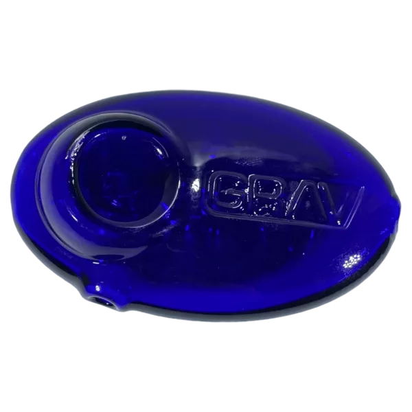 blue plastic spoon with a pebble-shaped handle and the word Grav written in black on it. It is listed on a smoking company website.