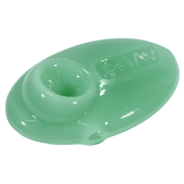 Green plastic spoon with small and large ends, attached by a hinge. Smooth surface, made of light plastic.