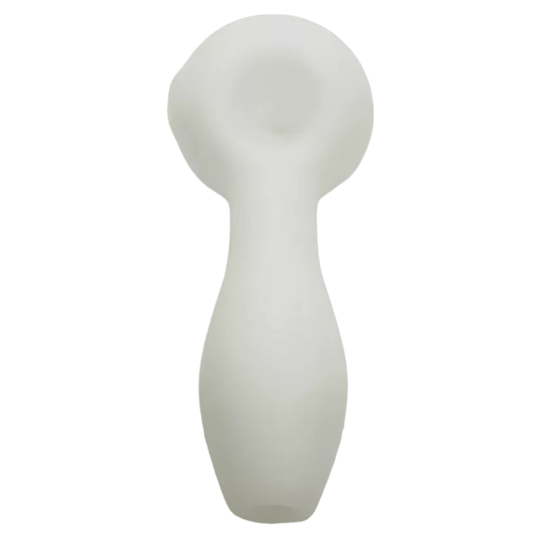 Hand-carved, porous spoon with abstract design created by blowing air. Sits on green surface and has a slightly blurred image.